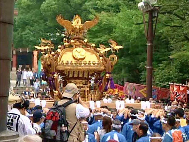 Carrying a portable shrine 1